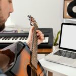 giovane ragazzo che accorda la chitarra