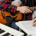 giovane musicista che si esercita con la chitarra